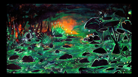 Still from the video Raúl Recio: Paisaje Invisible (English captioned) of an artwork by Raúl Recio featuring a black background with bright green water, vegetation, trees and orange reflective accents.