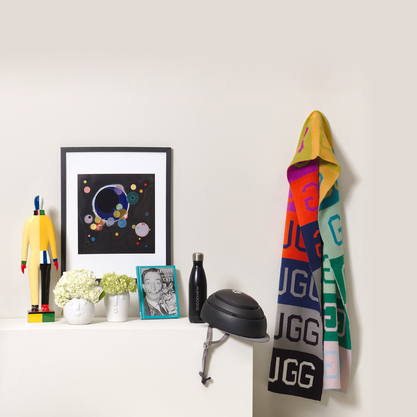 A framed print, wooden figurine, colorful scarf and other Guggenheim Museum products