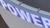 The word "power" displayed across an LED sign in a neon indigo color.