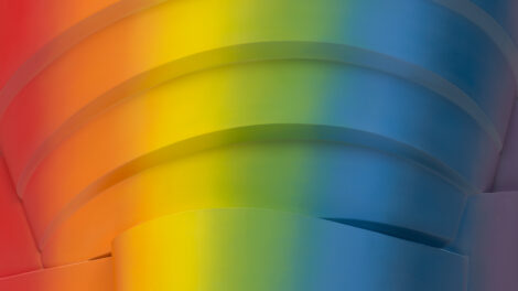 Abstract image of layered arcs resembling a spiral structure, covered in a rainbow gradient.