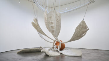 Claes Oldenburg and Coosje van Bruggen's Soft Shuttlecock , 1995 featuring Canvas, latex paint, expanded polyurethane foam, polyethylene foam, steel, aluminum, rope, wood, duct tape, fiberglass, and reinforced plastic, and nine feathers.